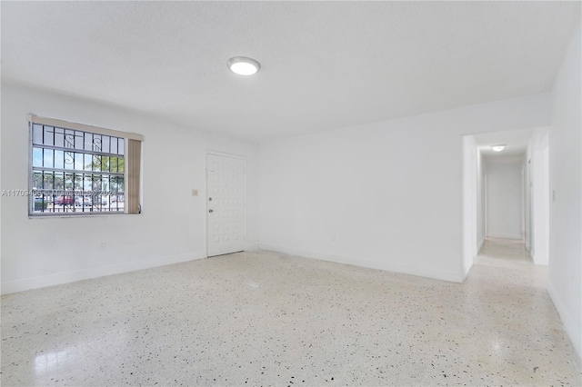 empty room with a textured ceiling