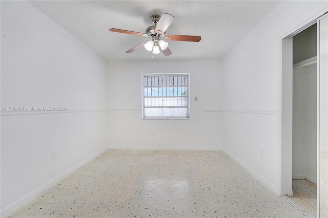 interior space featuring ceiling fan and a textured ceiling