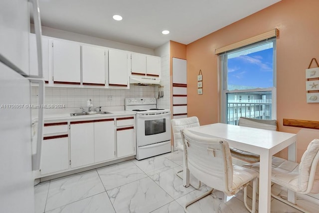 kitchen featuring white cabinets, decorative backsplash, white appliances, and sink