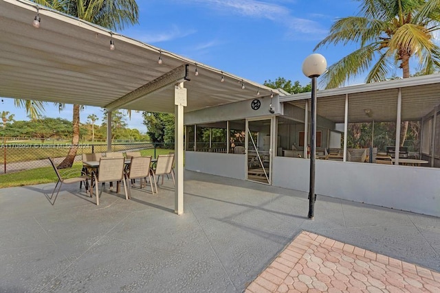 view of patio with a sunroom