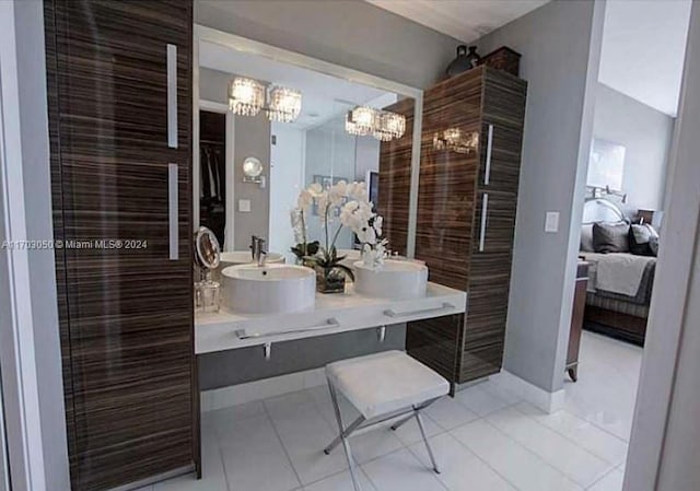 bathroom featuring tile patterned flooring, vanity, and a chandelier