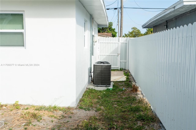 view of side of home with central AC unit