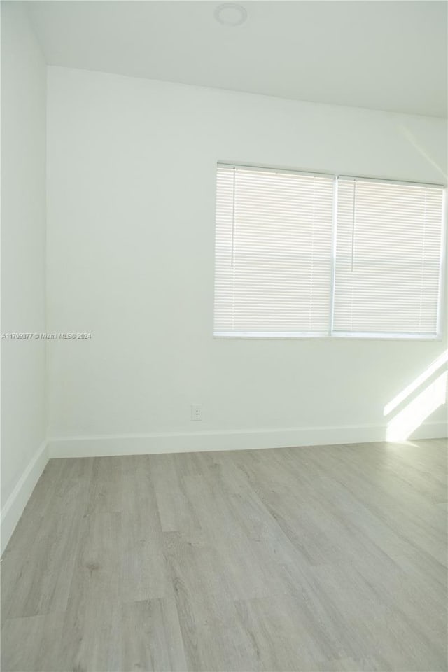 spare room with light wood-type flooring