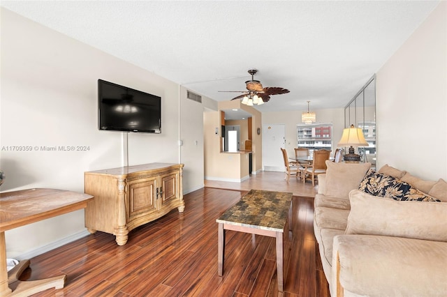 living room with hardwood / wood-style floors, a textured ceiling, and ceiling fan