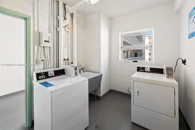 washroom featuring washing machine and dryer and sink