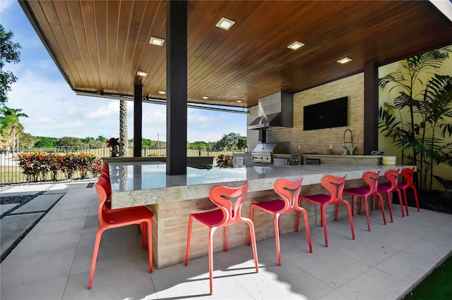 view of patio / terrace featuring area for grilling and a wet bar