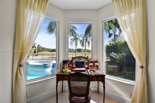 bedroom with access to outside and a tray ceiling