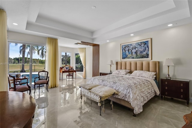 bedroom with a tray ceiling and access to outside