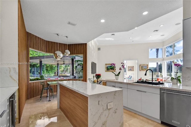 2445 Provence Cir, Weston, FL 33327 - kitchen featuring stainless steel dishwasher, a kitchen island, modern cabinets, white cabinets, and a sink