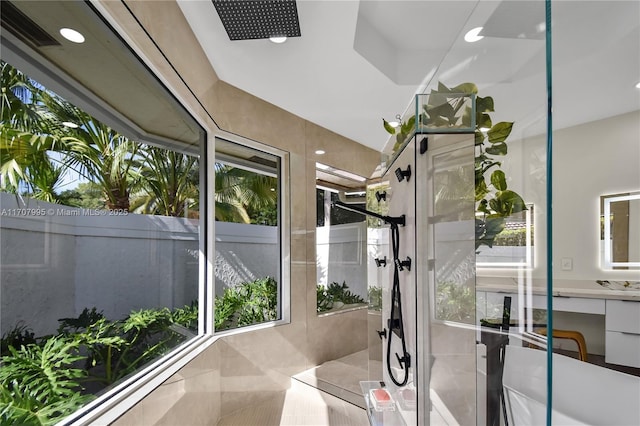 bathroom with vanity and a tile shower