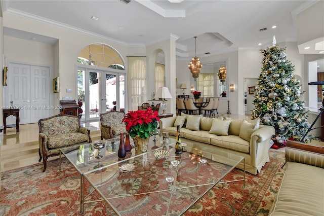 living room featuring ornamental molding, french doors, and a chandelier