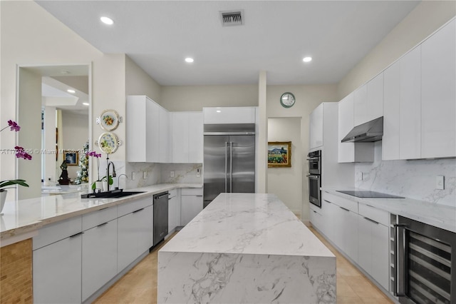 kitchen featuring sink, a center island, wine cooler, exhaust hood, and appliances with stainless steel finishes