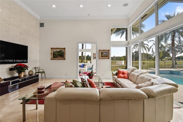 tiled living room with ornamental molding and a high ceiling