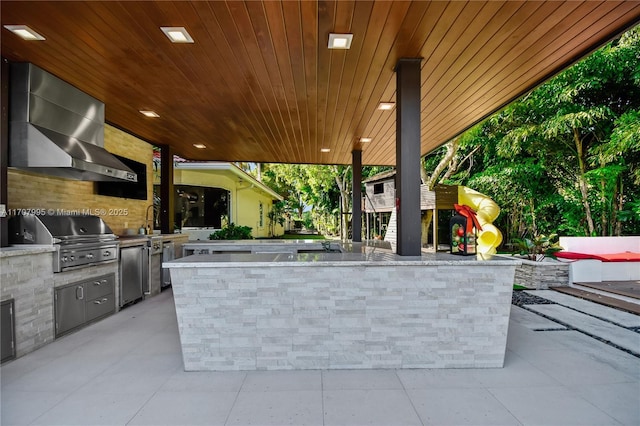 view of patio featuring a grill and an outdoor kitchen