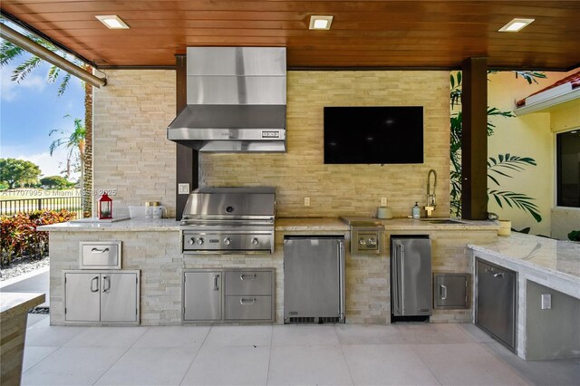 view of patio with grilling area, sink, and exterior kitchen