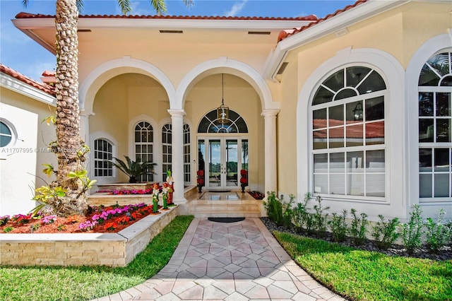 view of exterior entry featuring french doors