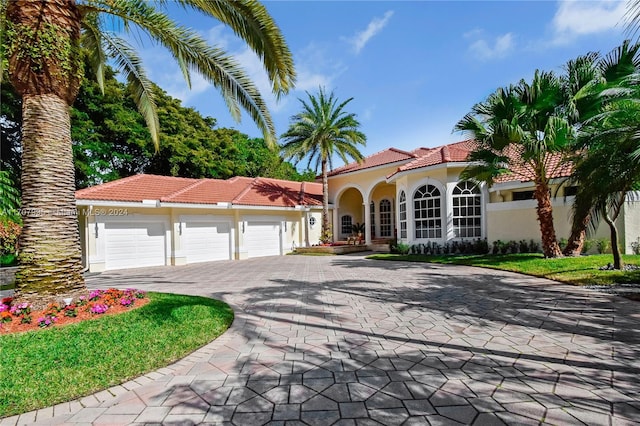 mediterranean / spanish house featuring a garage