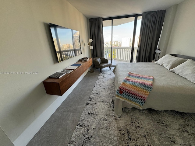 bedroom featuring access to outside and a wall of windows