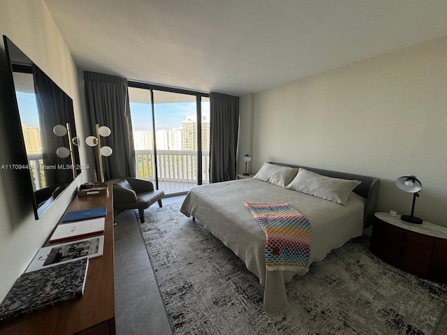 bedroom featuring access to outside and a wall of windows