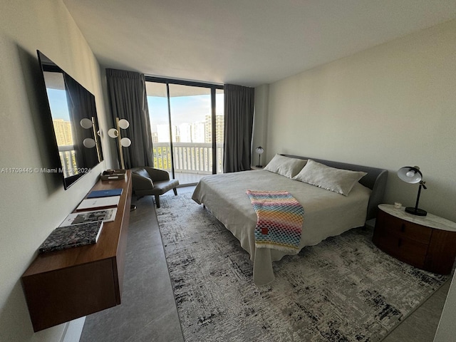 bedroom featuring access to outside and a wall of windows