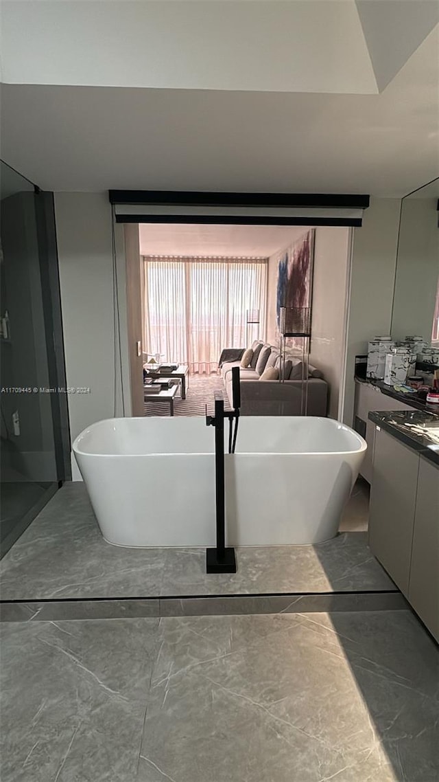 bathroom featuring a washtub and vanity