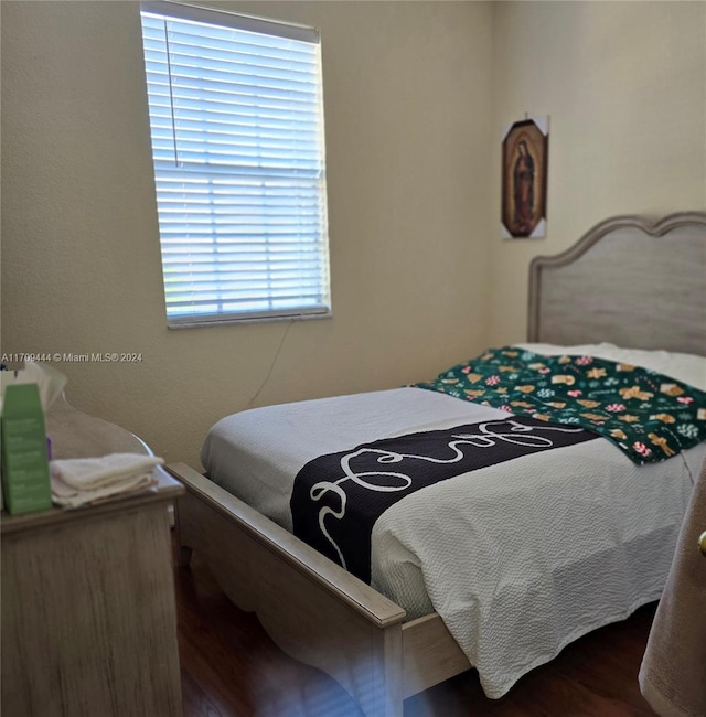 bedroom with dark wood-type flooring