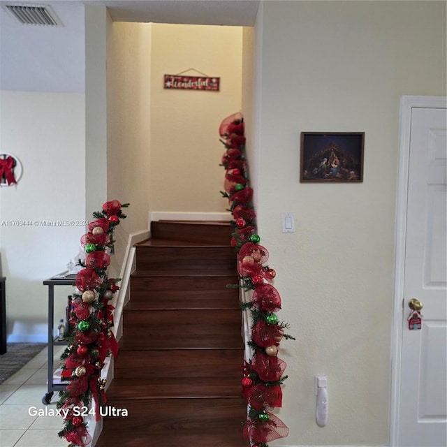 stairs featuring tile patterned flooring