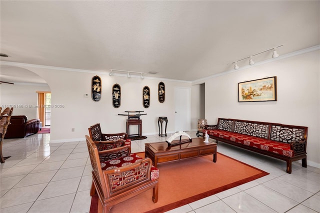 tiled living room featuring crown molding and rail lighting