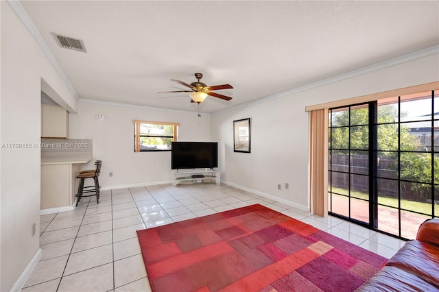 unfurnished living room featuring ceiling fan, light tile patterned floors, and ornamental molding