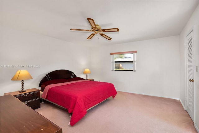 carpeted bedroom with a closet and ceiling fan