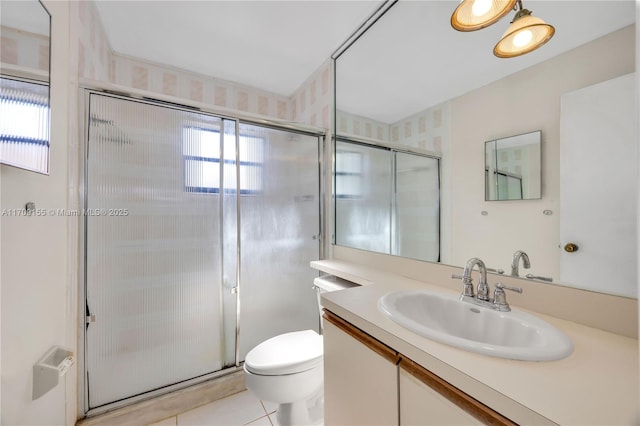 bathroom featuring tile patterned floors, vanity, an enclosed shower, and toilet