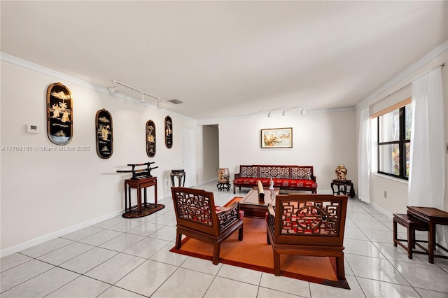 tiled dining area featuring crown molding and track lighting