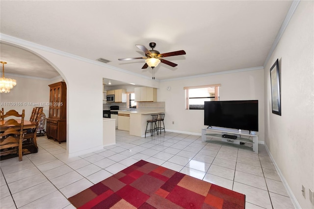 living room with ceiling fan with notable chandelier, light tile patterned floors, and ornamental molding