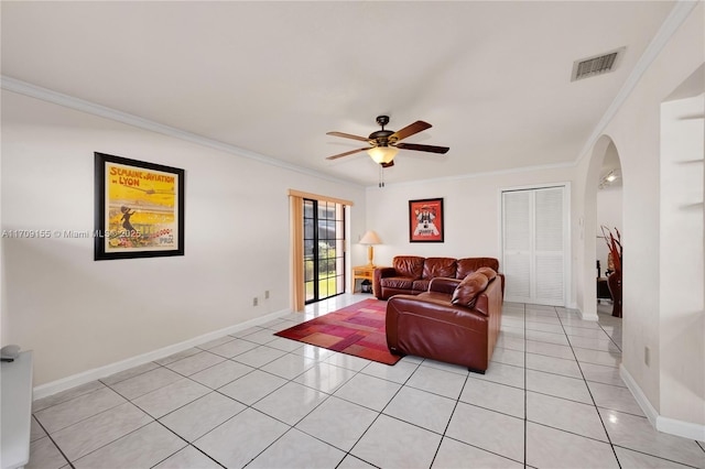 tiled living room featuring ceiling fan and crown molding