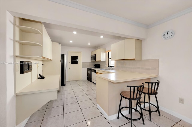 kitchen featuring stainless steel appliances, tasteful backsplash, kitchen peninsula, a kitchen bar, and light tile patterned flooring