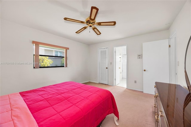 bedroom featuring ceiling fan, light carpet, connected bathroom, and a closet