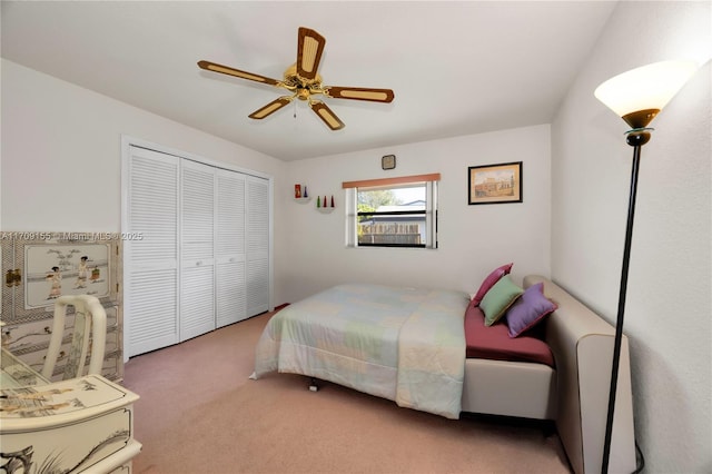 bedroom with carpet flooring, ceiling fan, and a closet