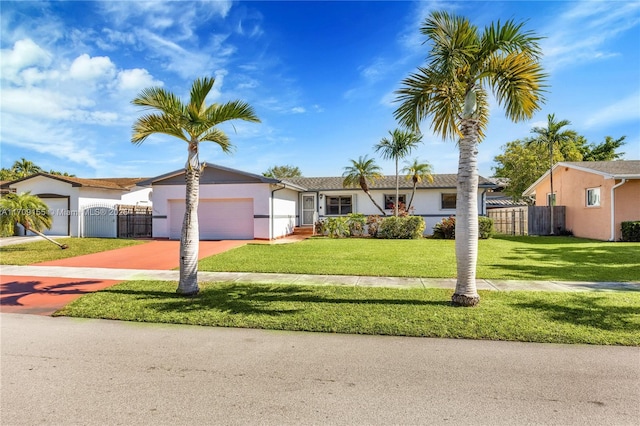 view of front of property with a front yard and a garage