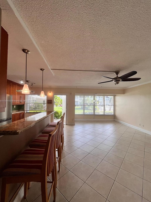 interior space with ceiling fan and a textured ceiling