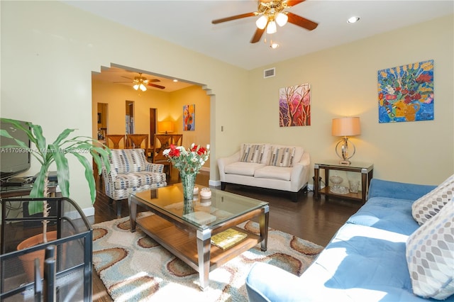 living room with dark hardwood / wood-style floors and ceiling fan