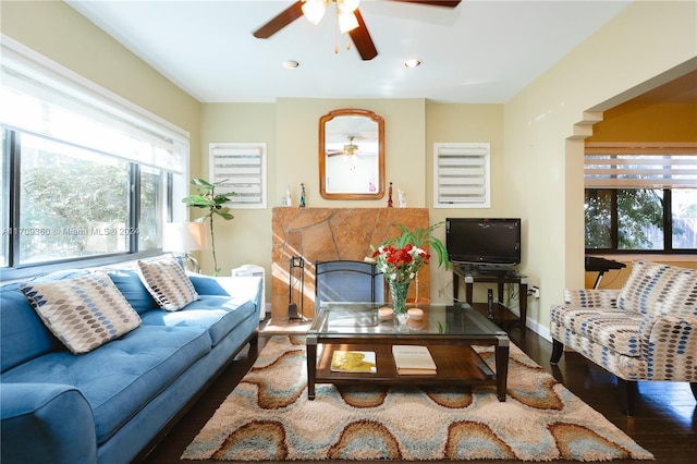 living room with ceiling fan and dark hardwood / wood-style flooring