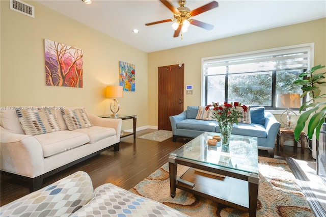 living room featuring ceiling fan and dark wood-type flooring