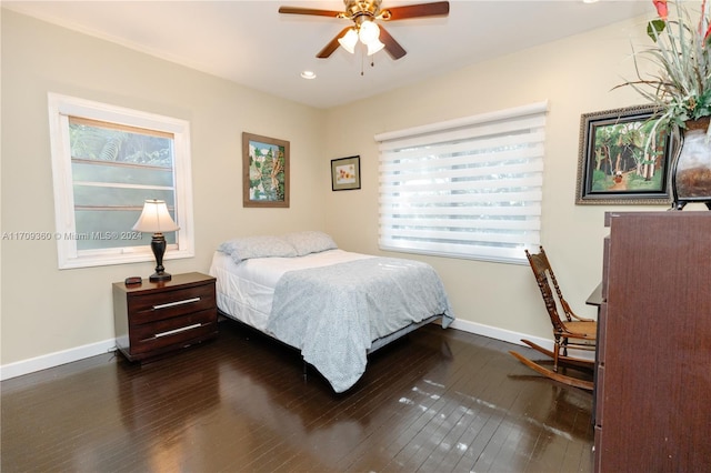 bedroom with ceiling fan and dark hardwood / wood-style flooring