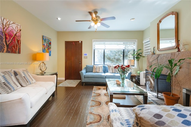 living room with ceiling fan and dark hardwood / wood-style flooring