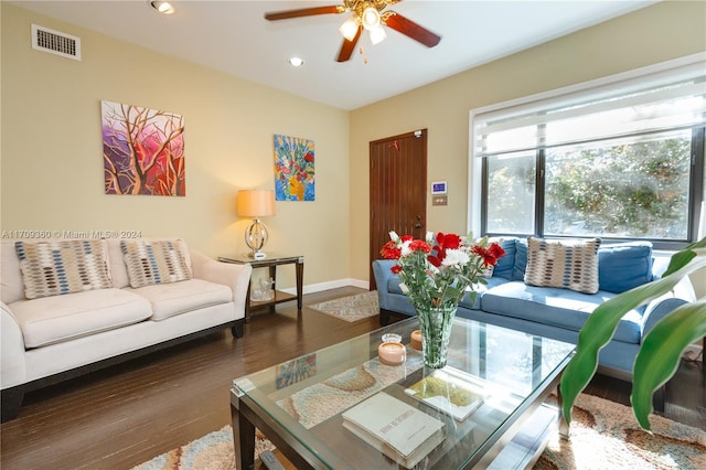 living room featuring ceiling fan and dark hardwood / wood-style flooring