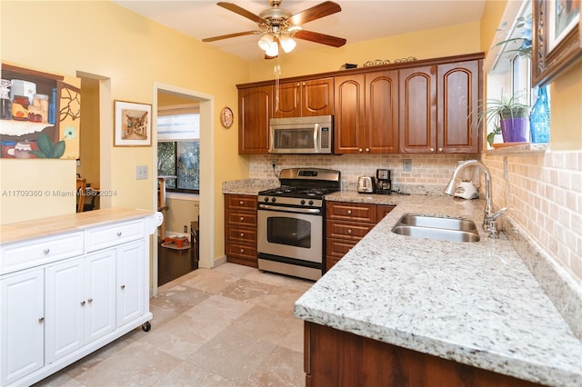 kitchen with plenty of natural light, sink, appliances with stainless steel finishes, and tasteful backsplash