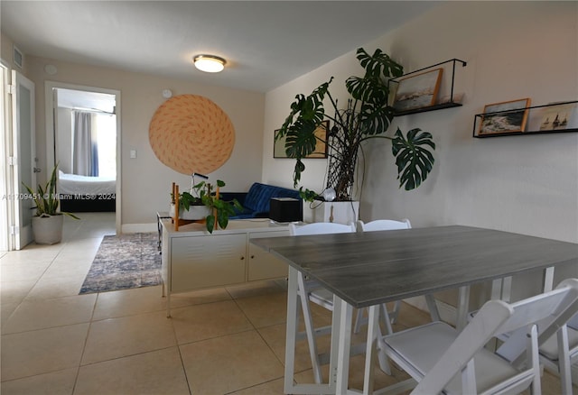 dining space featuring light tile patterned floors