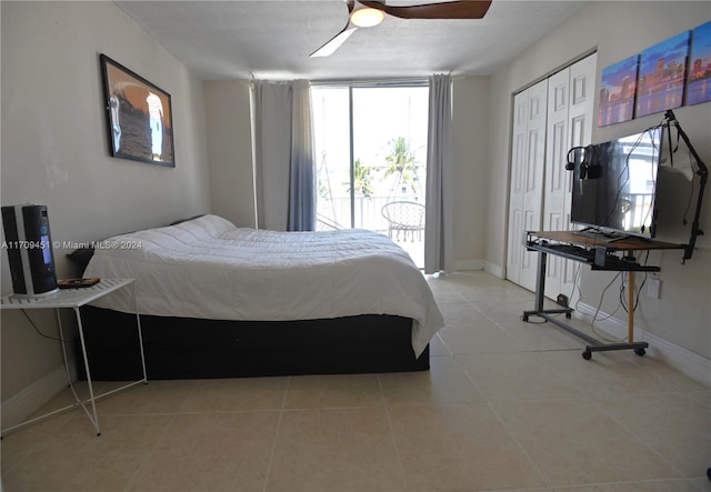 tiled bedroom with multiple windows, ceiling fan, a closet, and access to exterior