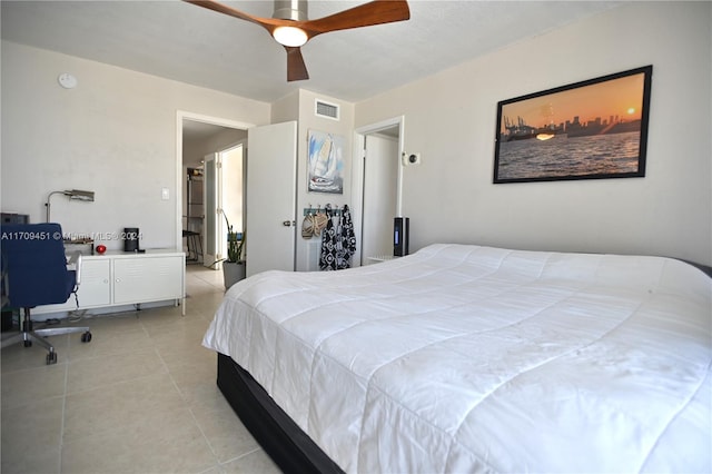 tiled bedroom featuring ceiling fan