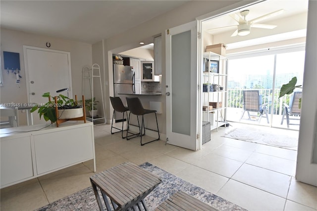 living room featuring ceiling fan and light tile patterned flooring